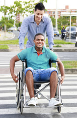 Fototapeta na wymiar young man in a wheelchair outside