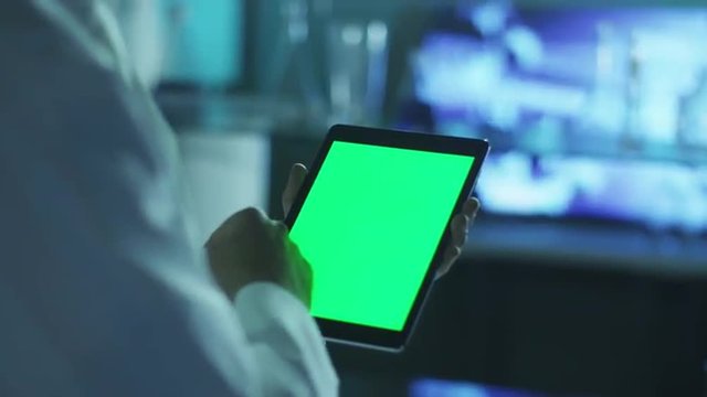 Using Tablet with Green Screen in Portrait Mode. Scientific Environment.