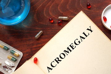 Acromegaly  written on book with tablets. Medicine concept.