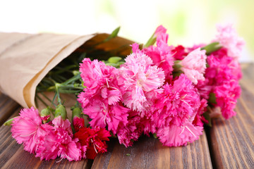 Beautiful bouquet of pink carnation on bright background