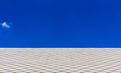 Brown tile roof on blue sky.