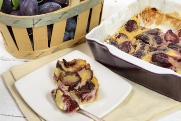 plum clafoutis with a basket of plum