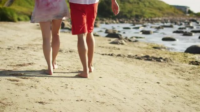 Couple is Walking on the Beach in Sunny Day. Slow Motion 60 FPS.