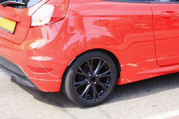 back of the sport car with a black wheel