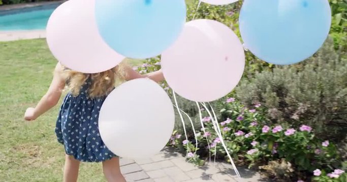 Little Blonde girl running with balloons in slow motion