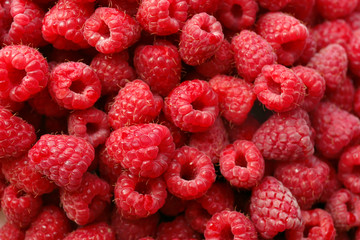Heap of sweet red raspberries close up