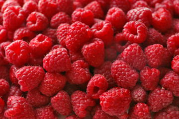 Heap of sweet red raspberries close up