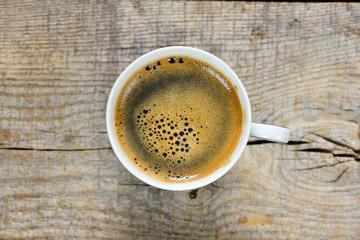 Tasty Coffee in cup on background