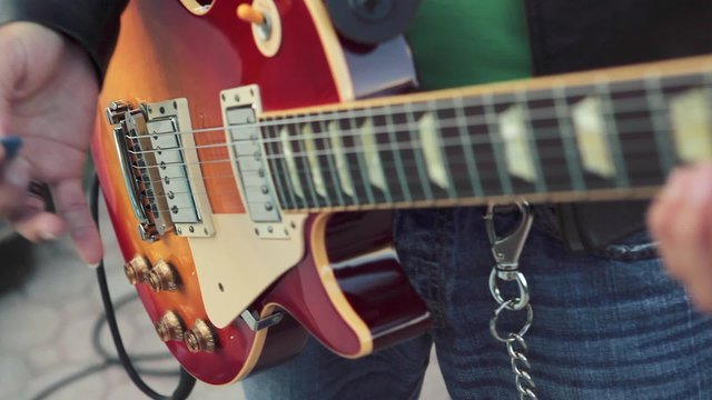 Great shot of guitarist's hands playing the electric guitar