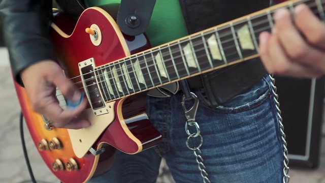 Cool shot of Guitar player's hands playing electric guitar