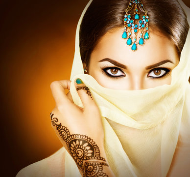 Beautiful indian girl portrait. Young hindu woman with mehndi tattoo