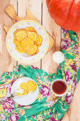 Pumpkin pancakes on the wooden background