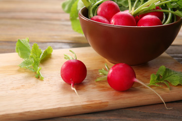 Fresh red radish on wooden table, closeup