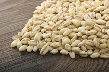 Spoon of Pearl barley close up on a table