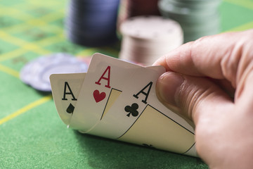 Hands holding poker cards