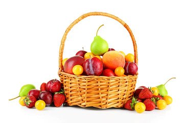 Heap of fresh fruits and berries in basket isolated on white
