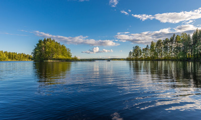 Landscape lake with reflection, clouds.