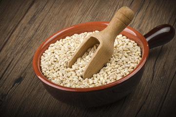 Spoon of Pearl barley close up on a table