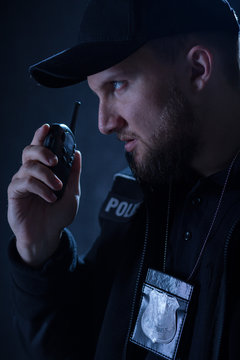 Policeman using walkie talkie