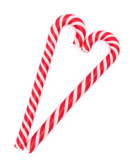 Red-white candy canes in shape of heart isolated on white