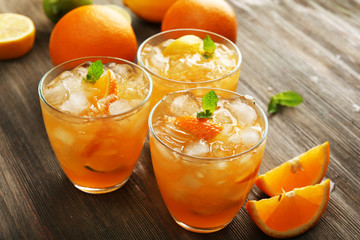 Glasses of orange juice on wooden table, closeup