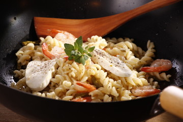 fresh shrimp with cheese and pasta in the pan 