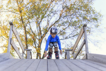 roller skating with slides.boy wants to slide down the slope on roller skates