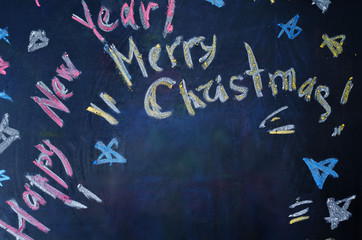 Fototapeta na wymiar Happy new year and merry Christmas written with chalk
