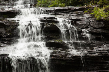 Fototapeta na wymiar Mountain waterfall tumbling over rocks