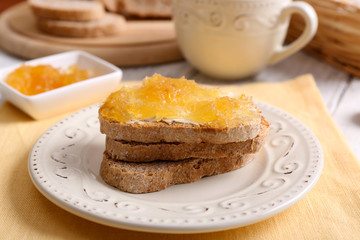 Fresh toast with butter and jam on table close up