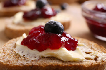 Fresh toast with butter and jam on table close up