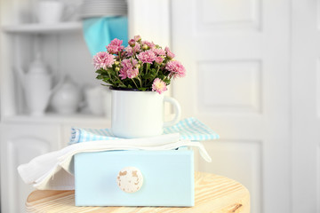 Beautiful flowers in decorative vase on light background