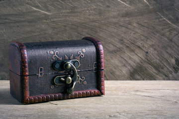 Treasure chest old close on wood background. Still life.
