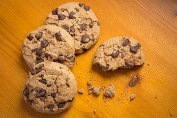 Chocolate chip cookies on wood background.