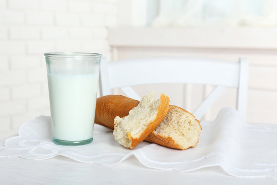 Milk with bread on table in kitchen