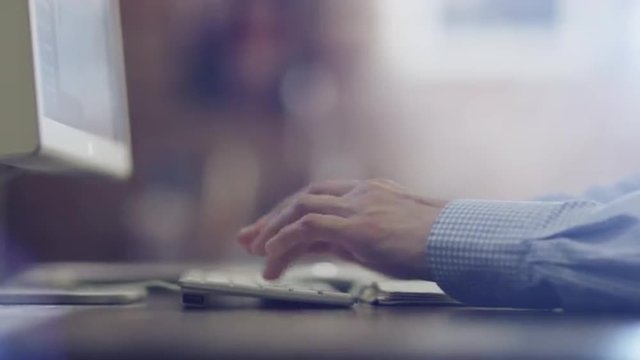 Designer Typing a Message at Evening