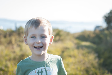 happy cheerful boy walking outdoors