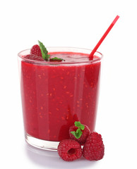 Glass of fresh raspberry cocktail and raspberries isolated on white