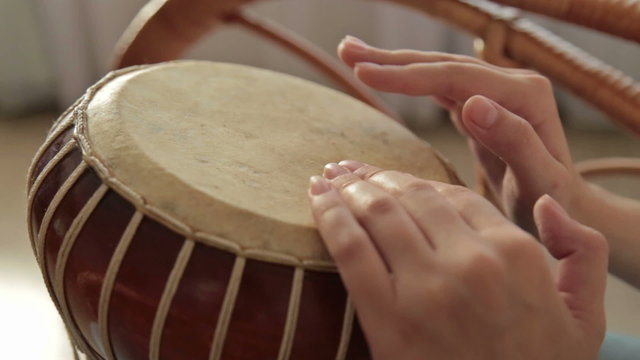 Woman banging a bongo