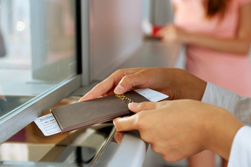 Woman buying tickets with passport at box office