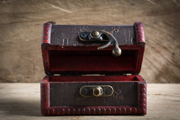 Treasure chest old open on wood background. Still life.