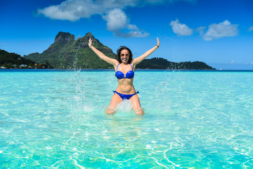Girl with blu nikini jumping in Bora Bora