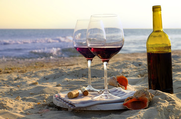 Wine bottle and glasses on the seashore