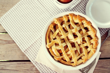 Homemade apple pie on wooden background