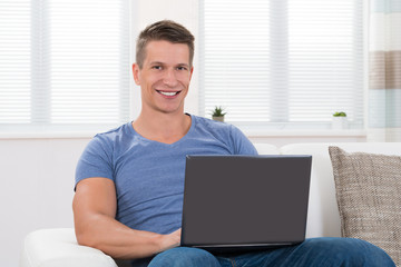 Man On Sofa Using Laptop