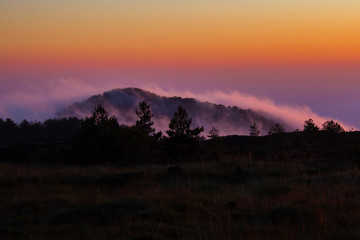 Fog envelops an old crater of the volcano Etna