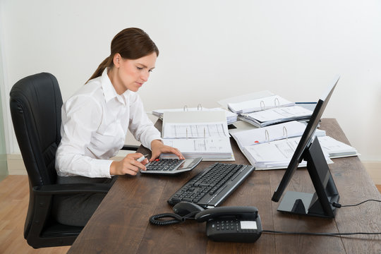 Accountant Doing Calculation At Desk