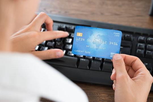 Businessperson Using Computer Keyboard And Credit Card
