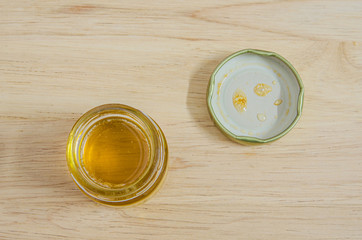 Jars of honey on wooden table