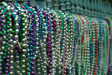 Alignment of multiple colored beads on a fence in New Orleans in Louisiana after the Mardi Gras...